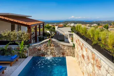 a swimming pool on the side of a house at Moana House in Sálakos