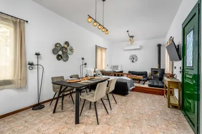 a living room with a table and a couch at Moana House in Sálakos