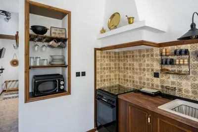 a small kitchen with a stove and a microwave at Moana House in Sálakos