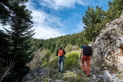 a man and a woman walking on a mountain trail at Moana House in Sálakos