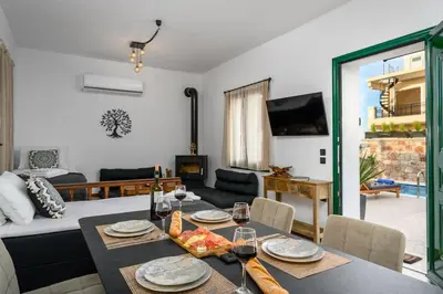 a living room with a table with glasses of wine at Moana House in Sálakos
