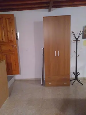 a room with a wooden door and a cross on the wall at House of dreams in Rhodes Town