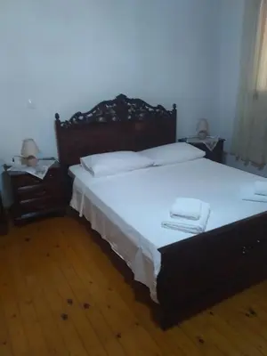 a bedroom with a large bed with white sheets and pillows at House of dreams in Rhodes Town