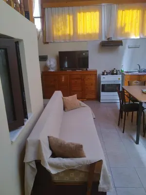 a living room with a bed and a kitchen at House of dreams in Rhodes Town