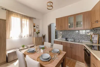 a kitchen with a table and chairs in a kitchen at Knights Golden Loch - Rhodes Unique Getaway in Rhodes Town