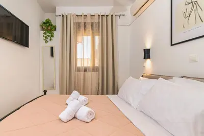 a bedroom with a white bed with towels on it at Knights Golden Loch - Rhodes Unique Getaway in Rhodes Town