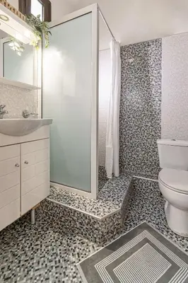 a bathroom with a shower and a toilet and a sink at Knights Golden Loch - Rhodes Unique Getaway in Rhodes Town