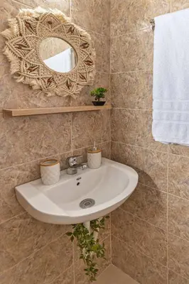 a bathroom with a sink and a mirror at Knights Golden Loch - Rhodes Unique Getaway in Rhodes Town