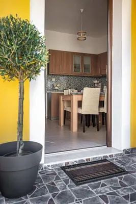 a dining room with a table and a potted tree at Knights Golden Loch - Rhodes Unique Getaway in Rhodes Town