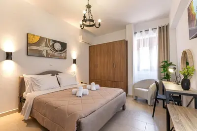 a bedroom with a bed and a table and a desk at Knights Golden Loch - Rhodes Unique Getaway in Rhodes Town