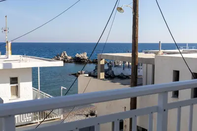 a view of the ocean from the balcony of a building at Georgias Apartments in Haraki