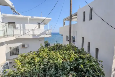 a view of the ocean from between two buildings at Georgias Apartments in Haraki