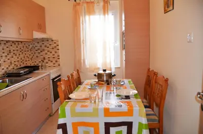 a kitchen with a table with a table cloth on it at Georgias Apartments in Haraki