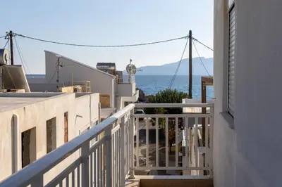 a view of the ocean from the balcony of a house at Georgias Apartments in Haraki