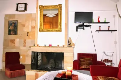 a living room with a fireplace and a mirror at La Casa Di Silvia in Apolakkiá