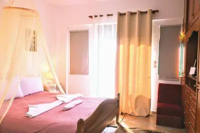 a bedroom with a bed with a mosquito net at La Casa Di Silvia in Apolakkiá