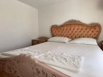 a bedroom with a large bed with a wooden headboard at Casa Piaduli in Faliraki