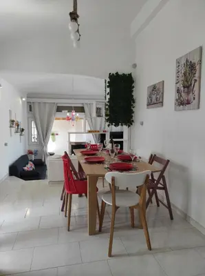 a dining room with a table and chairs in a room at Arocaria Apartment in Faliraki with garden , mountain and sea view in Faliraki