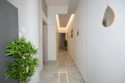 a hallway with white walls and a hallway with plants at Harmony Seaside House in Ialyssos