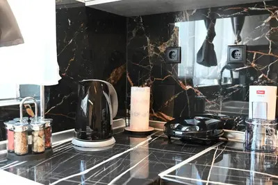 a kitchen counter with a coffee maker on a counter top at Harmony Seaside House in Ialyssos