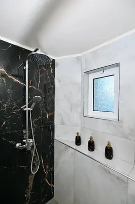 a bathroom with a shower and a window at Harmony Seaside House in Ialyssos