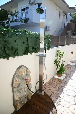 a light next to a rock next to a house at Harmony Seaside House in Ialyssos
