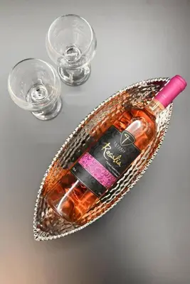 a bottle of alcohol in a basket with glasses at Harmony Seaside House in Ialyssos