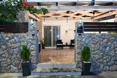 an entrance to a house with a stone wall at Harmony Seaside House in Ialyssos