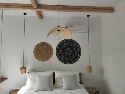 a bedroom with a bed with white sheets and pillows at THALASSA in Livadia
