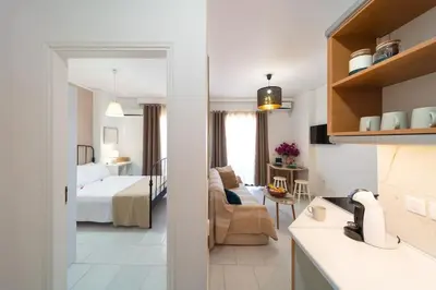 a kitchen and a bedroom with a bed and a living room at Urban Escape in Rhodes Town