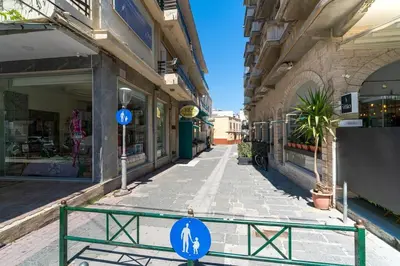 a street with a blue sign in front of a building at Urban Escape in Rhodes Town