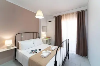 a bedroom with a large bed and a window at Urban Escape in Rhodes Town