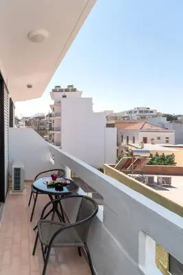 a balcony with two chairs and a table on a ledge at Urban Escape in Rhodes Town