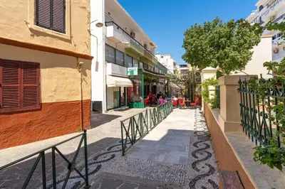 a city street with buildings and a fence at Urban Escape in Rhodes Town