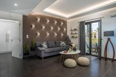 a living room with a couch and a table at Faliro Hotel in Faliraki