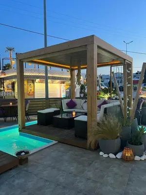 a patio with a gazebo and a pool at Faliro Hotel in Faliraki