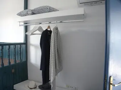 a closet with clothes hanging on a door at Evelia Sea House in Plimmiri