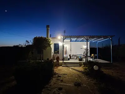 a gas station at night with a lit up building at Evelia Sea House in Plimmiri