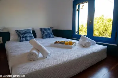 a bed with towels and a tray of food on it at Evelia Sea House in Plimmiri