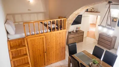 a room with a bed and a table and a dining room at Beaver's Nest in Profília