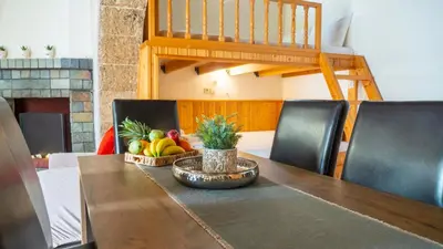 a wooden table with a bowl of fruit on it at Beaver's Nest in Profília