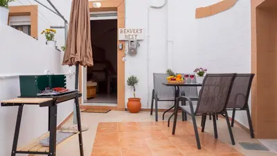 a patio with two chairs and a table with at Beaver's Nest in Profília