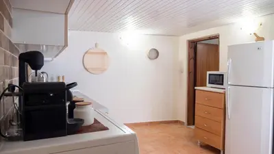 a kitchen with a white refrigerator and a microwave at Beaver's Nest in Profília