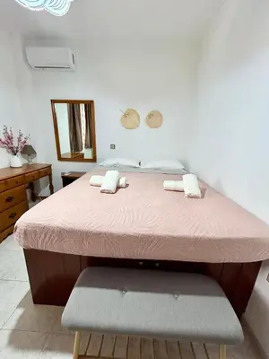a bed in a room with a pink mattress at Philoxenia House in Asklipio in Asklipiḯon