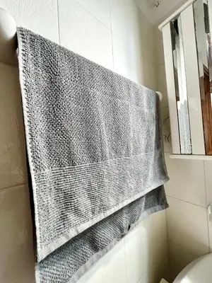 a gray towel hanging on a wall in a bathroom at Philoxenia House in Asklipio in Asklipiḯon