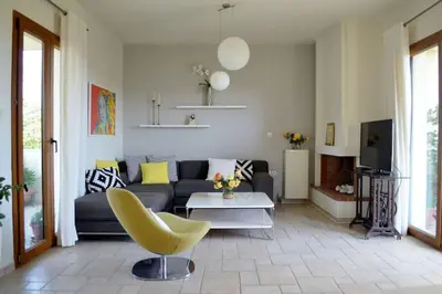 a living room with a couch and a yellow chair at Elektra Apartment-Kallithea in Kallithea Rhodes