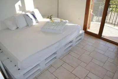 a large white bed in a room with a window at Elektra Apartment-Kallithea in Kallithea Rhodes