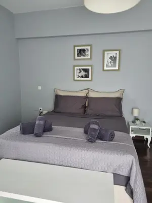 a bedroom with a large bed with purple pillows at Precious Emma's House in Afantou