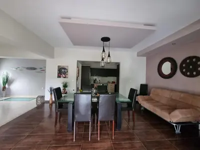 a living room with a dining room table and a couch at Precious Emma's House in Afantou
