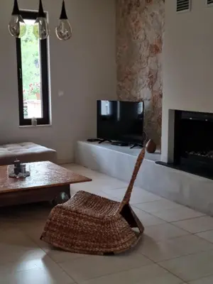 a living room with a chair and a television at Precious Emma's House in Afantou